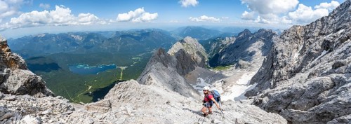 Panorama, mountaineer with helmet in a secured via ferrata, Zugspitze via ferrata, ascent to the