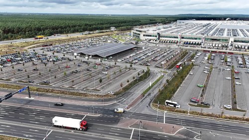 Tesla Giga Factory on the A10 motorway, in the centre of the picture is a photovoltaic system above