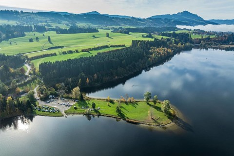 Sports facility and bathing area, lake Rottachsee, at village Petersthal, mt. Gruenten in the back,