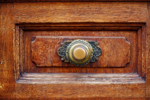Brass door knob, mounted on the panelled panel of a wooden door, Alter Peter in Munich, Bavaria,