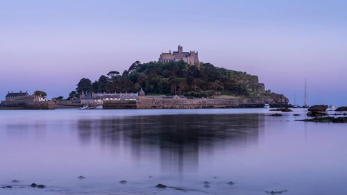 View of St Michaels Mount from Marazion Beach. In the evening after sunset, blue hour. St Michael's