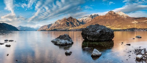 Evening atmosphere at Lago di Como with large boulders in the water, Lombardy, Italy, Europe