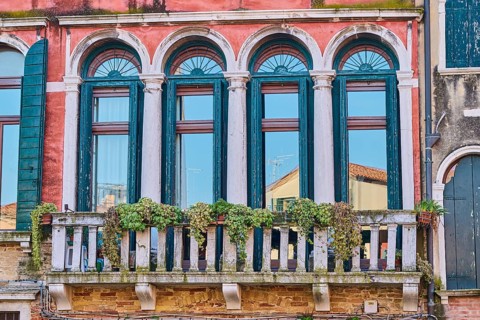 Windows of an old house on 'Campo santa margherita' town square in Venice on a sunny day in winter,