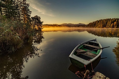 Boats in the autumnal Schmutter Weiher in the Allgäu near the municipalities of Halblech,