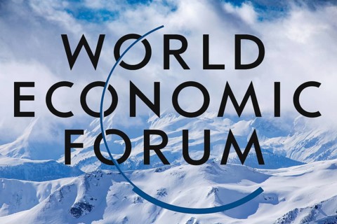 Logo of the WEF (World Economic Forum) against the background of a wintry snowy landscape in Davos