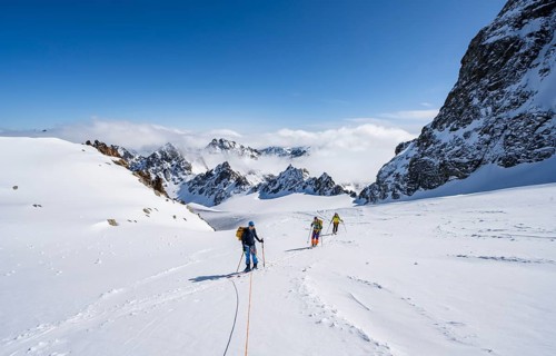 Ski tourer with rope, rope team on the Vadret da Porchabella glacier on the ascent to the summit of