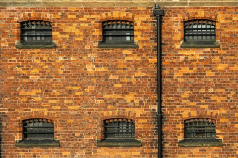Cell windows with bars, exterior of Victorian jail museum, Lincoln Castle, city of Lincoln,