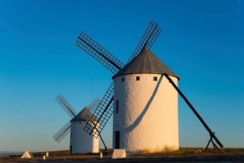 Two large white windmills in the morning sun with long shadows, Campo de Criptana, Ciudad Real