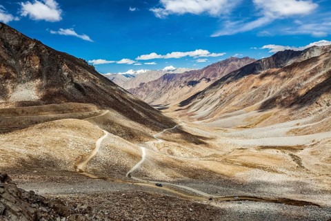 Himalayan valley landscape with road near Kunzum La pass, allegedly the highest motorable pass in