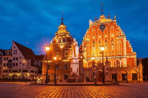 Riga Town Hall Square, House of the Blackheads and St. Roland Statue illuminated in the evening