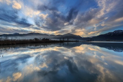 Mountains reflected in a lake at sunrise, cloudy mood, winter, Loisach-Lake Kochel moor, Alpine