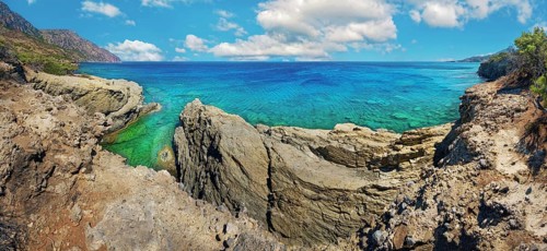Dramatic rock formations overlooking turquoise waters, hiking trail from Avlona to Diafani, Avlona,