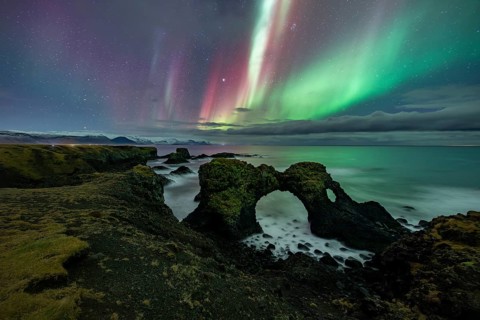 Northern lights over rock structure, coast near Arnarstapi, Snäfellsnes peninsula, Snæfellsnes,