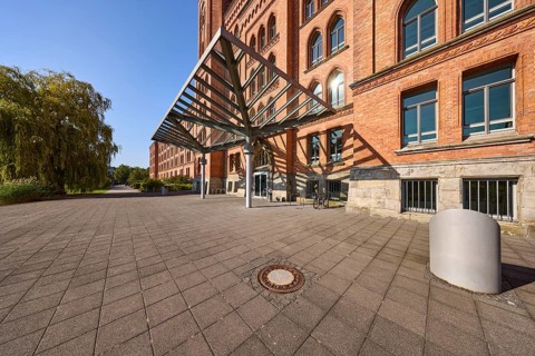 New town hall, brick architecture, architectural style neo-Gothic, high round window arches,
