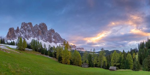 View of a part of the Geisler group in the foreground two alpine huts, sunset, Dolomites, snow,