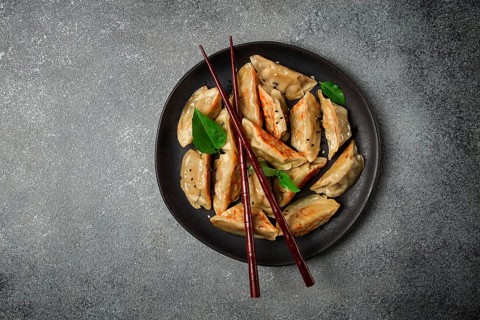 Japanese fried dumplings, gyoza, sesame seeds, top view, no people