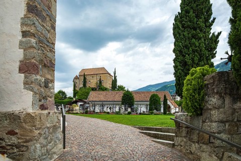 Picturesque cemetery with a view of Scena Castle, on the church hill of Scena above Merano, in the