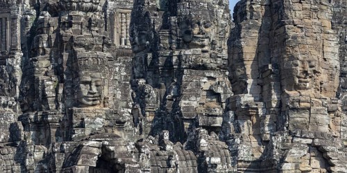 Panoramic image of giant stone-carved faces of the Bodhisattva Lokeshvara, also known as