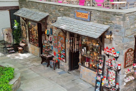 Inviting souvenir shop with various decorations and souvenirs on a stone facade, Makrinitsa,