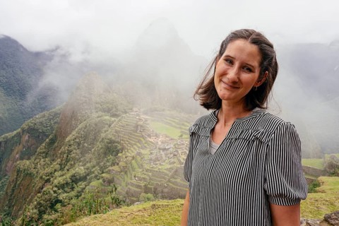 Young woman posing in front of Machu Picchu, Machu Picchu, Cusco Region, Peru, South America