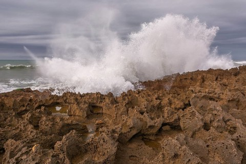The rocks are scattered throughout the area, with some of them being large and jagged. The water