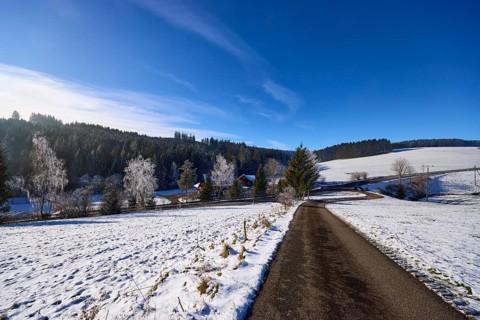 Hilly winter landscape, snow, road, blue sky with veil clouds, Titisee-Neustadt, Black Forest,