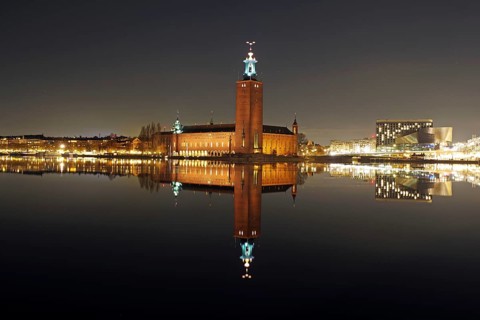 Night city view with illuminated tower and bridges in the background, winter, ice, capital, city