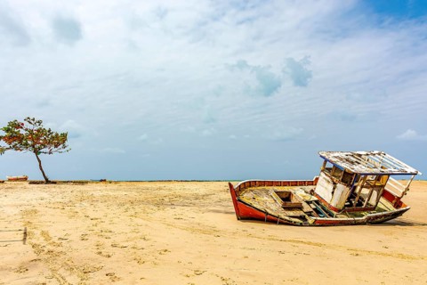 Deteriorated fishing trawler stranded on the beach sand in Olinda, Pernambuco, Olinda, Pernambuco,
