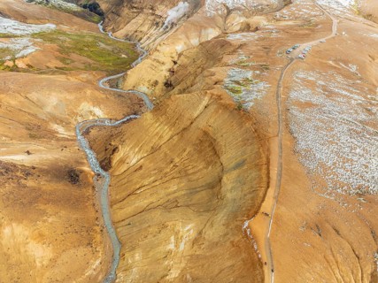 Steaming hot springs and colourful rhyolite mountains, parking lot, aerial view, Hveradalir