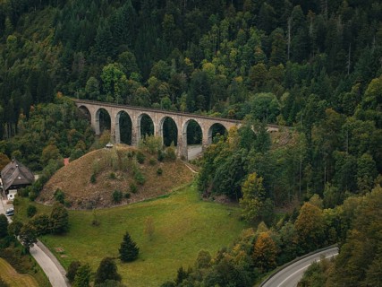Stone viaduct crosses green forest and hills, Ravenna Gorge, Black Forest, Germany, Europe