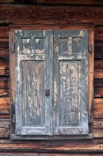 Detailed view of wooden shutters of a hut on an alpine meadow at the foot of the Peitlerkofel,