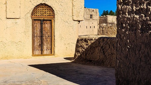 Decorated round arch entrance door in the largest preserved mud town in Oman, Al Bilaad, Al Bilaad