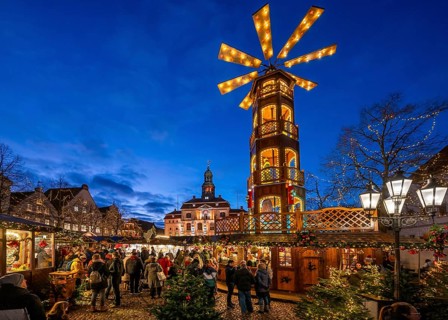 Christmas market with large Christmas pyramid on the market square, behind the historic town hall,