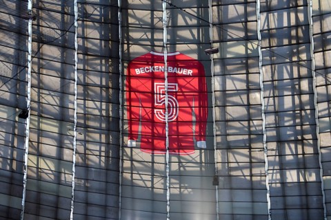 Larger-than-life jersey of Franz Beckenbauer with shirt number 5 hanging in the grandstand roof of
