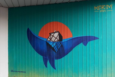 House sinks into an ocean wave in the shape of a whale, symbolic mural on the subject of climate