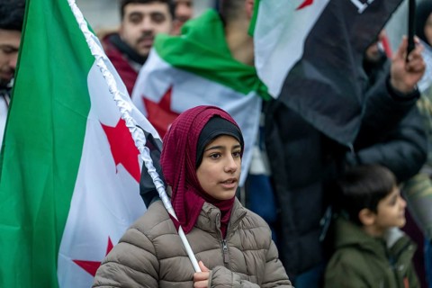 Syrian woman celebrate the end of the Assad regime after the change of power in Syria at a rally on