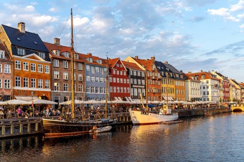 Colourful houses, restaurants and historic ships on the Nyhavn canal and harbour, Copenhagen,