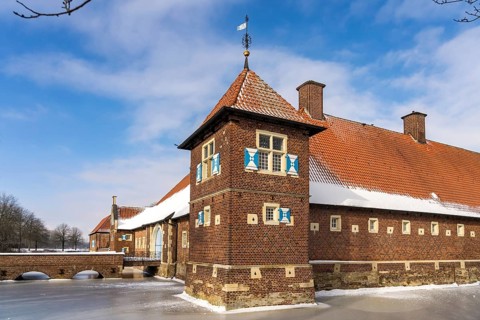The snow-covered moated castle Haus Borg in winter, Drensteinfurt, Münsterland, North
