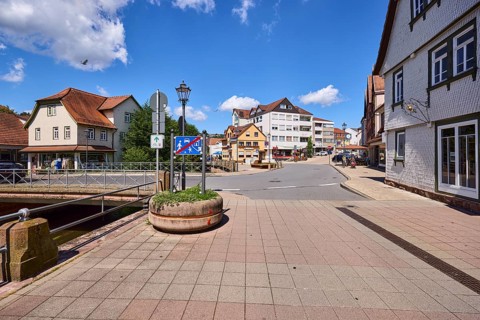 Car and pedestrian bridge, general development, lantern, pavement made of paving slabs, blue sky