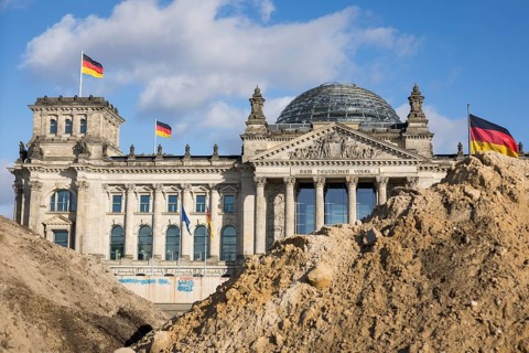 Reichstag building in Berlin Mitte behind Sandbergen due to construction work on the Platz der