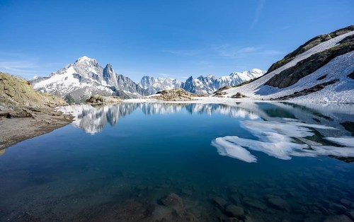 Mountain landscape with mountain lake, water reflection in Lac Blanc, mountain peak, Aiguille