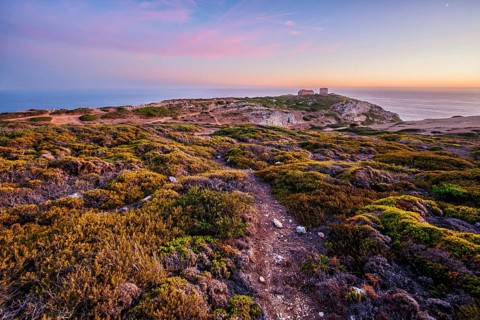 Cabo Espichel cape Espichel on Atlantic ocean at sunset with ruins