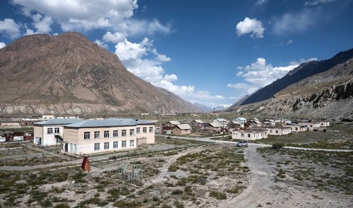 Abandoned ruined buildings in a mountain landscape, ghost town, Engilchek, Tian Shan, Kyrgyzstan,