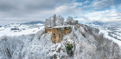 Aerial view, panorama of the snow-covered Hegau volcano Mägdeberg with remains of a castle wall on