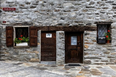 Entrance door and window of a typical Ticino stone house in the village of Sonogno, Verzasca