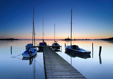 Dawn on the Schaalsee, wooden jetty with sailing boats, Schaalsee Biosphere Reserve,
