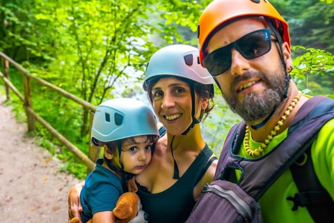 Happy family wearing helmets taking a selfie while visiting vintgar gorge in bled, slovenia