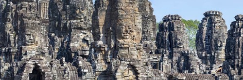 Panoramic image of giant stone-carved faces of the Bodhisattva Lokeshvara, also known as