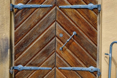 Detail of a historic iron-framed wooden door in the outer wall of the Old Palace in Stuttgart,