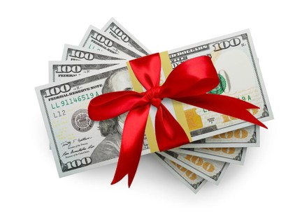 Fifty thousand dollars stack of one hundred dollar bills wrapped in a red bow isolated on a white